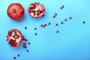 Ripe pomegranates on color background