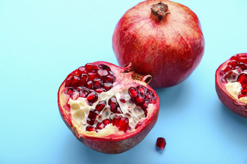 Ripe pomegranates on color background