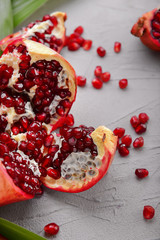 Ripe pomegranate on grey background