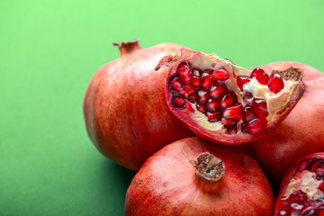 Ripe pomegranates on color background, closeup