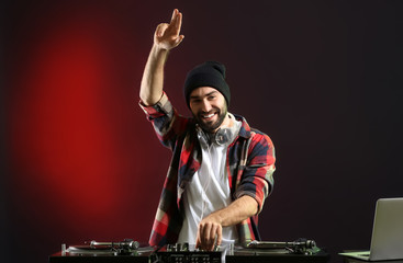 Male DJ playing music in club