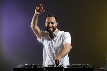 Male DJ playing music in club