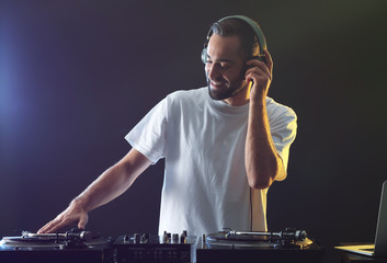 Male DJ playing music in club