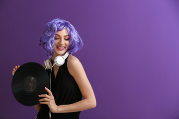 Beautiful young woman with vinyl disk and headphones on color background - obrazy, fototapety, plakaty