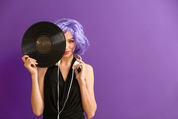Beautiful young woman with vinyl disk and headphones on color background - obrazy, fototapety, plakaty