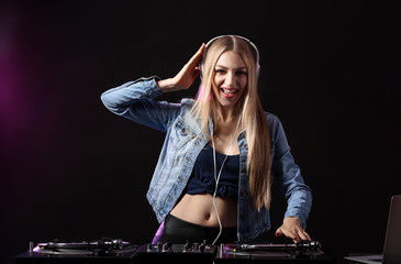 Fototapeta na wymiar Female DJ playing music in club
