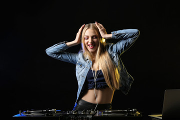 Female DJ playing music in club