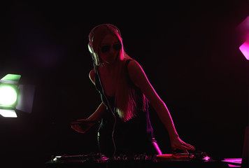 Female DJ playing music in club