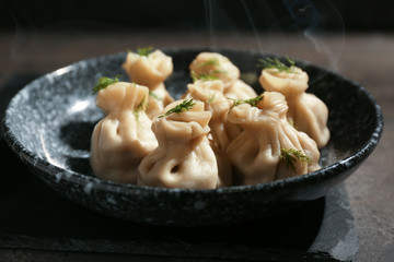 Plate with tasty dumplings on table