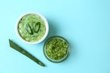 Facial mask with aloe vera extract on color background