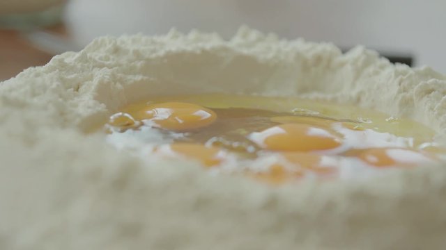 Egss in flour well, 4k slow motion