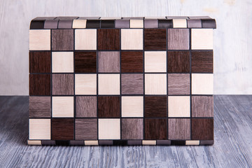 An angular tile with black and brown inserts