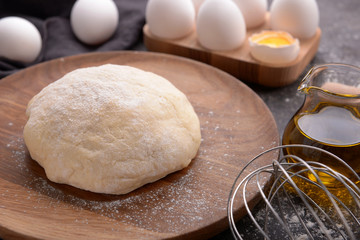 Raw dough for making bread on table