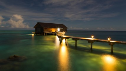 Wooden hut on stilts in lagoon at night, Gangehi Island, Ari Atoll, Indian Ocean, Maldives, Asia