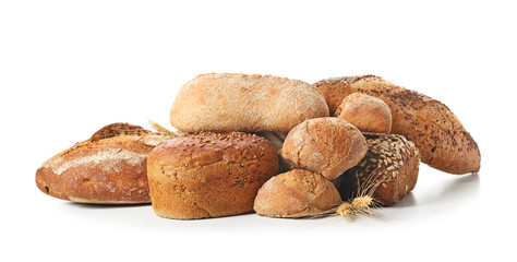Loaves of fresh bread on white background