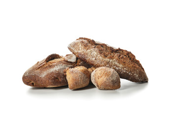 Loaves of fresh bread on white background