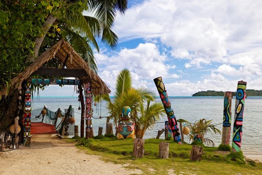 Totem poles at the entrance to the pearl farm The Farm, Bora Bora Island, Society Islands, French Polynesia, Oceania