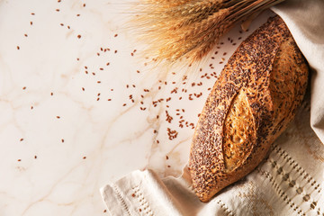 Loaf of fresh bread on light background