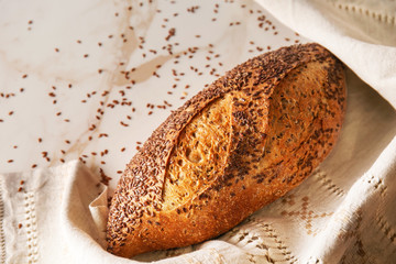 Loaf of fresh bread on light background