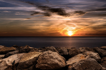 Sunset in the Mediterranean Sea with breakwater
