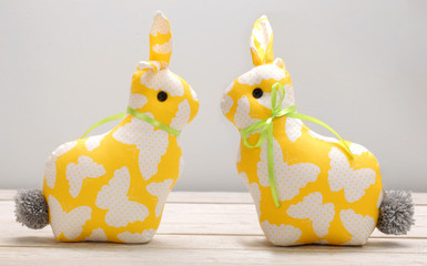 Two Easter yellow bunnies and empty space for text. Easter holiday concept.