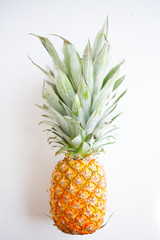 Creatively positioned pineapples on a white background