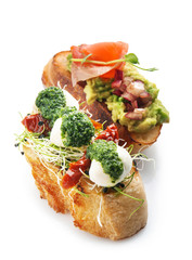 Fresh tasty bruschettas on white background