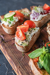 Fresh tasty bruschettas on wooden board