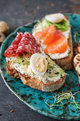 Plate with fresh tasty bruschettas on grey background