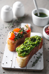 Board with fresh tasty bruschettas on table