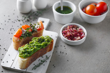 Board with fresh tasty bruschettas on table