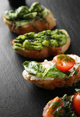 Fresh tasty bruschettas on dark background