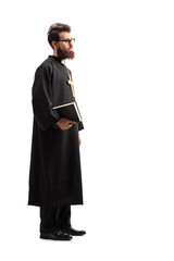 Priest standing and holding the Bible