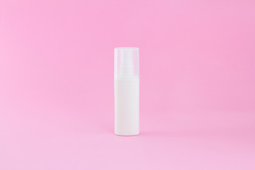 Blank packaging cosmetic pump bottle on pink background, close up mockup cream spray object