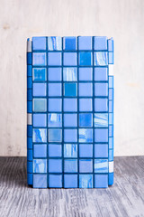 An exhibition sample of a blue tile with marble inserts