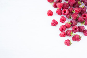 Sprinkled raspberries on white background. Ripe raspberries with copy space for text. Raspberry on...