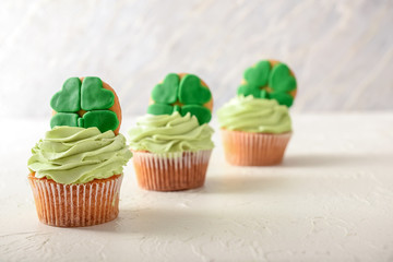 Obraz na płótnie Canvas Tasty cupcakes for St. Patrick's Day celebration on white table