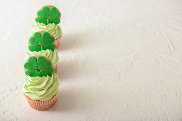 Tasty cupcakes for St. Patrick's Day celebration on white table