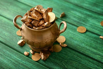 Pot of gold on wooden table. St. Patrick's Day celebration