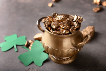 Pot of gold with clover on grey background. St. Patrick's Day celebration