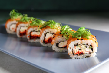 Tasty sushi rolls on plate, closeup