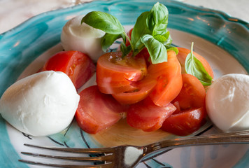 Buffalo mozzarella with fresh tomatoes and basilic at Positano  restaurant. Selective focus.