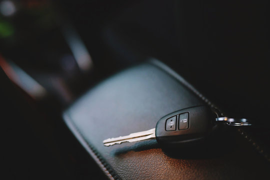 Close Up Of A Car Key Ring And Remote Control Alarm System Charm In Vehicle New Car Interior. Soft Focus. 