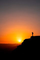 Photographer who shoots a sunset in the mountains