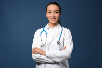 Female doctor on color background