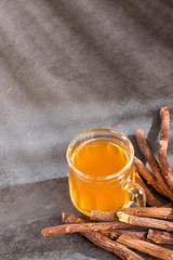 Close up of Ayurvedic herb Liquorice root,Licorice root, Mulethi or Glycyrrhiza glabra root on a wooden surface is very much beneficial for Soothes your stomach,poisoning, stomach ulcers.