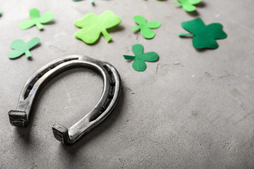 Horseshoe and clover on grey background. St. Patrick's Day celebration