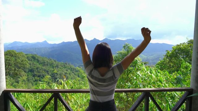 young japanese teen girl brunette tourist adult woman asian mature backpack looking the sky outdoors on a hike mountains viewpoint at Thong Pha Phum national park, kanchanaburi, Thailand.
