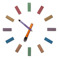 Analog clock made of eyeshadow and brushes isolated on white background. Makeup time at 6:52am