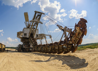 Extraction of sand in the quarry of a huge excavator.